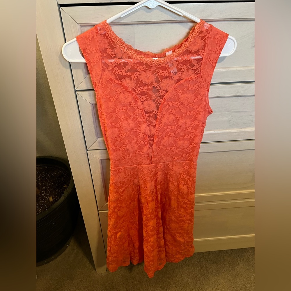 Pink owl peach color dress with lace plunging neckline.